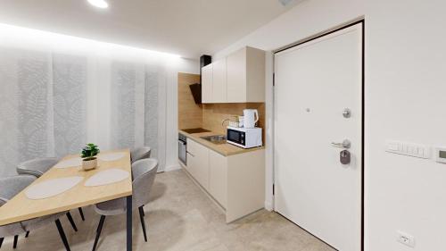 a kitchen with a table and chairs in a room at Calypso Residence in Umag
