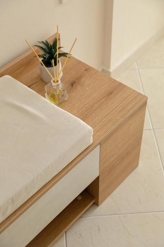 a wooden coffee table with a potted plant on it at Feel Like home appartment in Xanthi
