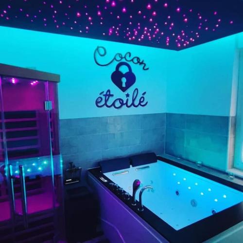 a room with a bath tub with a heart edit sign at Cocon Etoilé SPA PRIVATIF ET CIEL ÉTOILÉ in Le Havre