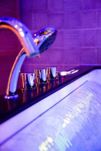 a close up of a bathroom sink with a faucet at Cocon Etoilé SPA PRIVATIF ET CIEL ÉTOILÉ in Le Havre