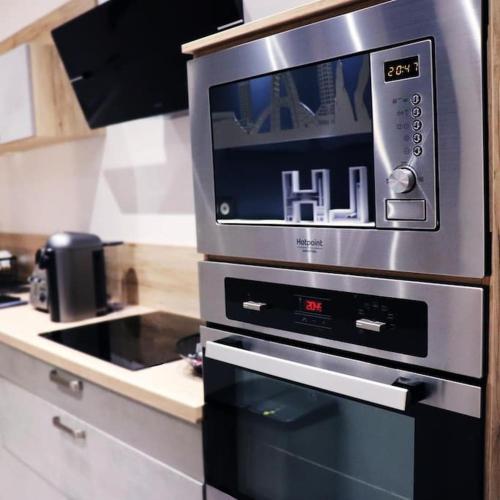 a microwave oven sitting on top of a kitchen counter at Cocon Etoilé SPA PRIVATIF ET CIEL ÉTOILÉ in Le Havre