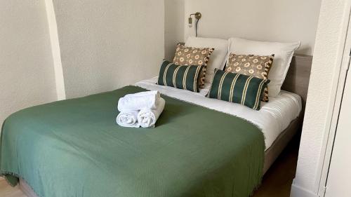 - un lit avec des serviettes et des oreillers dans l'établissement La parenthèse, à Nevers