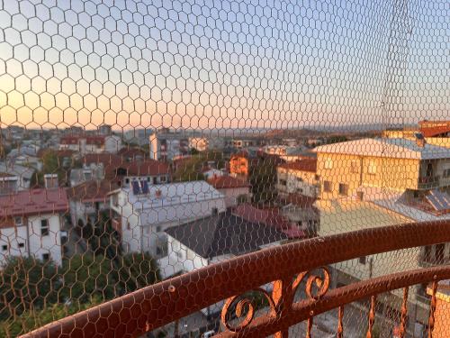 a view of a city through a wire fence at Sparta- Minimalism in Kavadarci