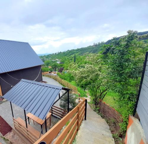 an overhead view of a house with a fence and benches at კოტეჯი ბუნებით და ლამაზი ხედებით in Surami
