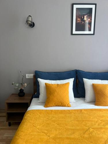 a bedroom with a bed with a yellow blanket at Fiesta Apartment on Franka 2BR-6P in Lviv