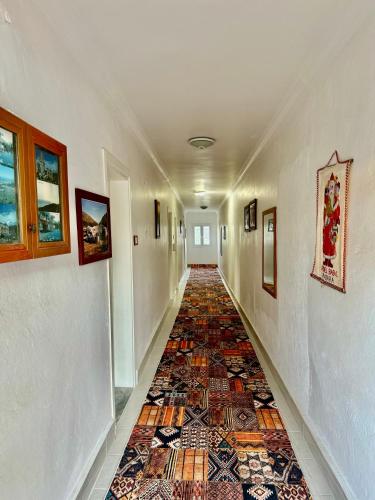 a hallway with a colorful tile floor in a house at Rose Hotel B&B in Patara