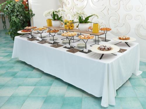 a table with a buffet of food on it at Hotel Le Agavi in Positano