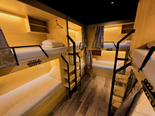 a group of bunk beds in a room at Travelogue Guest House in Kuala Lumpur