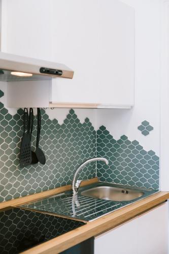 a kitchen with a sink and a counter top at Eliolite Holiday House in Scala