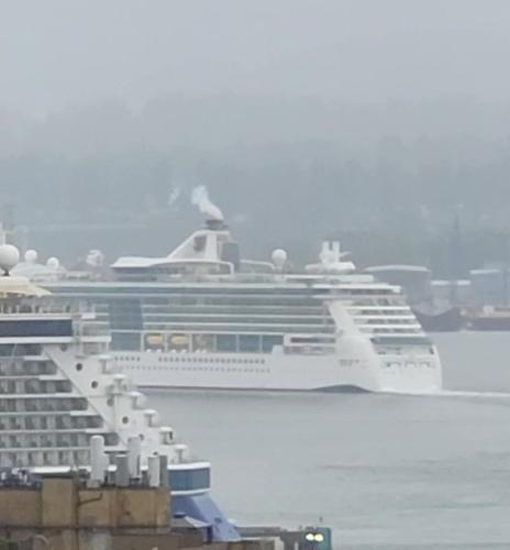 a cruise ship is docked in the water at Vancouver Downtown Accommodation in Vancouver