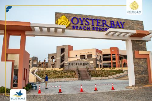 a sign for the osterley bay beach resort at Oyster bay Suite 01 in Abu Dabab