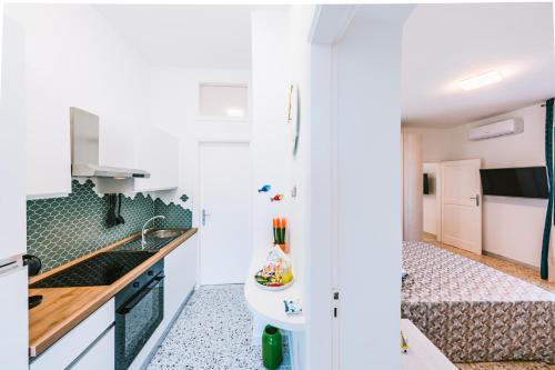 a kitchen with a sink and a bath tub at Eliolite Holiday House in Scala