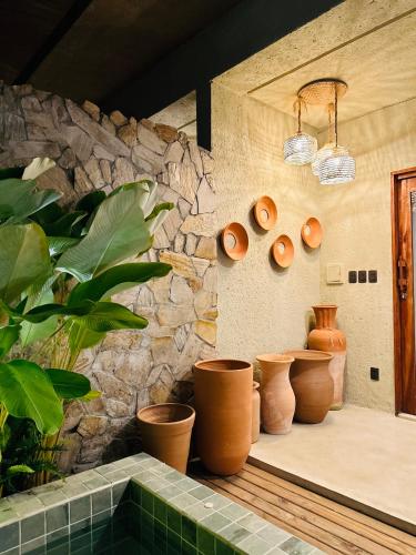a bunch of pots sitting on a counter in a room at Villa Aconchego - Casas de Luxo in São Miguel dos Milagres