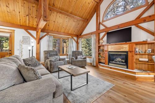 a living room with a couch and a fireplace at Whispering Pines Cabin in Rapid City