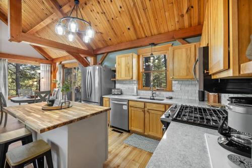 a kitchen with wooden cabinets and a stove top oven at Whispering Pines Cabin in Rapid City
