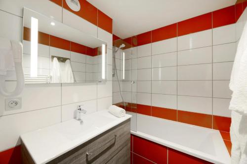 La salle de bains est pourvue d'un lavabo et de carrelage rouge et blanc. dans l'établissement Résidence Backgammon - LE BACKGAMMON MAE-3412, à Les Coches