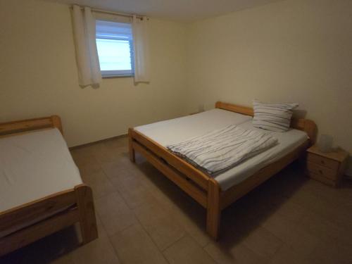 a small bedroom with a bed and a window at Villa Seeschwalbe Plau in Plau am See