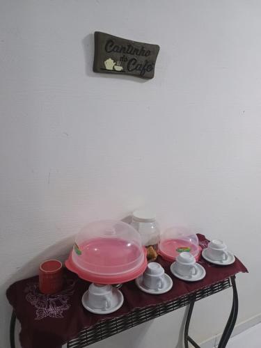 a table with two plates and bowls on it at Casa Temporada em Barreirinhas in Barreirinhas