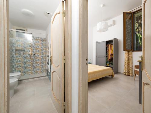 a bathroom with a shower and a bed in a room at Casa Vittorina - De Vivo Realty Positano in Positano