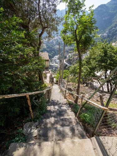 a path leading up to a hill with a view at Casa Vittorina - De Vivo Realty Positano in Positano
