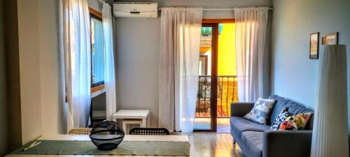 a living room with a blue couch and a balcony at La Pura Vida in Tazacorte