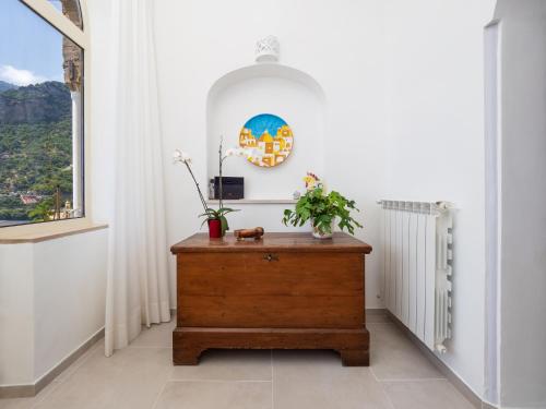 a room with a wooden dresser and a window at Casa Vittorina - De Vivo Realty Positano in Positano