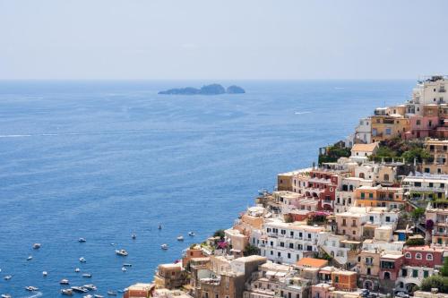 a view of the amalfi coast with boats in the water at Casa Vittorina - De Vivo Realty Positano in Positano