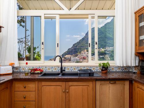 a kitchen with a sink and a window at Casa Vittorina - De Vivo Realty Positano in Positano