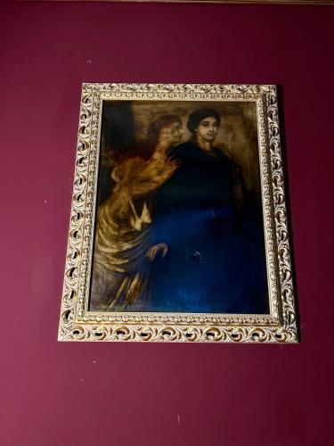 a painting of two people in a frame on a wall at Classic Love Story in Old Cluj I in Cluj-Napoca