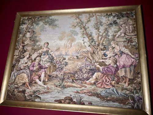 a tapestry hanging on a wall with people in a garden at Classic Love Story in Old Cluj I in Cluj-Napoca