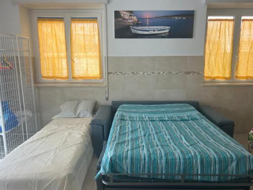 Ένα ή περισσότερα κρεβάτια σε δωμάτιο στο Marzamemi Beach Sun Sea