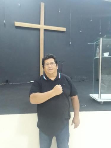 a man standing in front of a cross at Chalé do Coqueiro in Luis Correia
