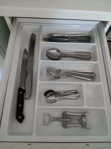 a drawer filled with silver utensils in a kitchen at appartamento piano terra in Eraclea Mare