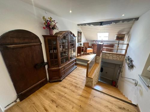 a room with a wooden door and a living room at Nannerls Penthouse in Sankt Gilgen