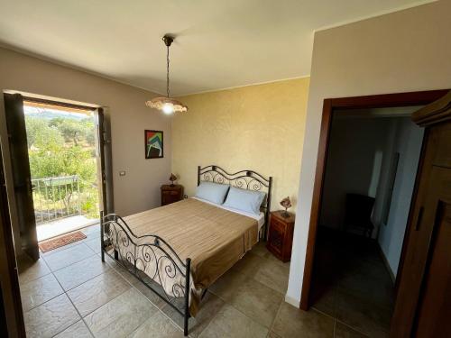 a bedroom with a bed in a room with a window at Agriturismo Serre in SantʼAgata di Militello