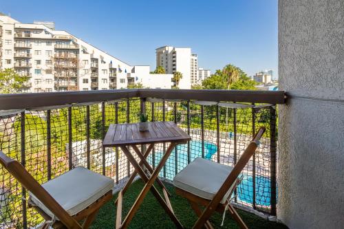 a balcony with two chairs and a table on a balcony at Beautiful Zen Nest 1mile New EPIC Universe in Orlando