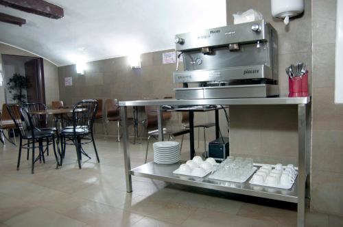 a kitchen with a stove and a table with chairs at Be Ramblas Guest House in Barcelona