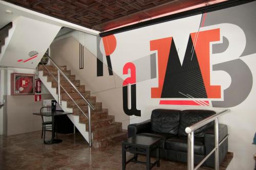 a living room with a couch and a staircase at Be Ramblas Guest House in Barcelona