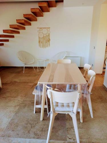 a dining room with a table and white chairs at Villa Cirasa in Aragona