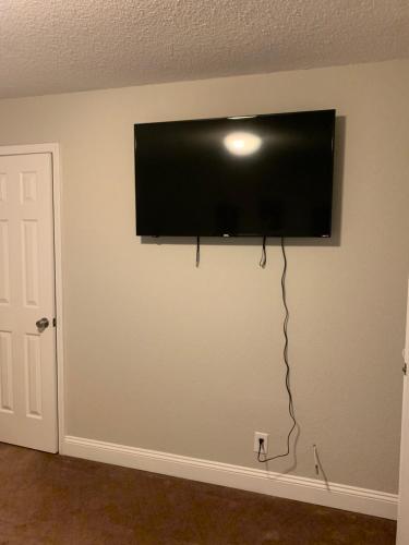 a flat screen tv hanging on a wall at Good Times in Charlotte