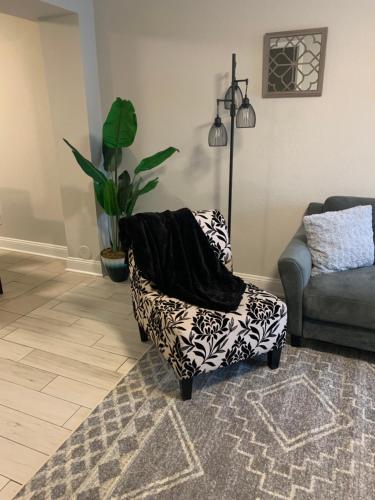 a living room with a chair with a blanket on it at Good Times in Charlotte