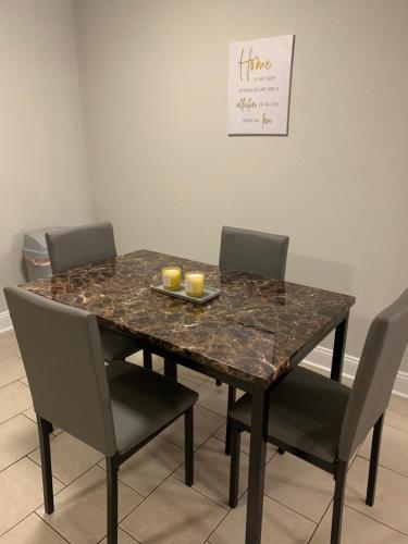 a dining room table with four chairs and a marble table at Good Times in Charlotte