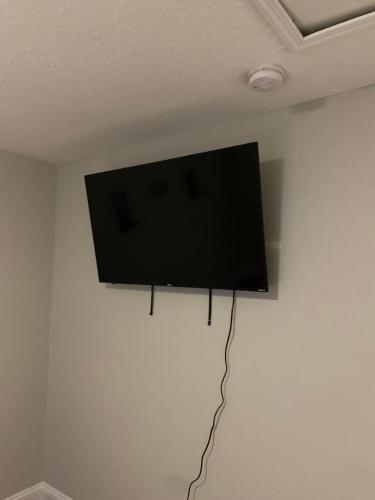 a flat screen tv hanging on a wall at Good Times in Charlotte