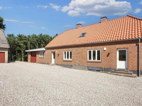a brick house with a driveway in front of it at 4 star holiday home in Ørum Djurs-By Traum in Ulstrup