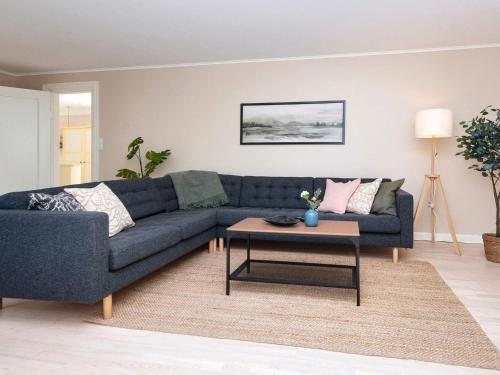 a living room with a blue couch and a table at 4 star holiday home in Ørum Djurs-By Traum in Ulstrup