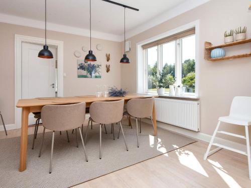 a kitchen and dining room with a wooden table and chairs at 4 star holiday home in Ørum Djurs-By Traum in Ulstrup