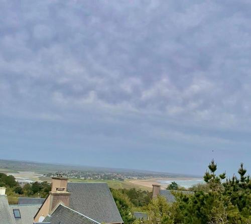 a view of the ocean from the roof of a house at Refuge des Sables Marins in Barneville-Carteret