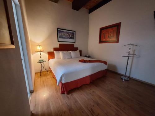 a bedroom with a large bed in a room at Hotel del Capitán de Puebla - Vitrales in Puebla