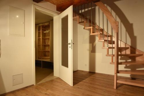 a hallway with a wooden staircase in a house at Kleines Ferienhaus in Umkirch in Umkirch