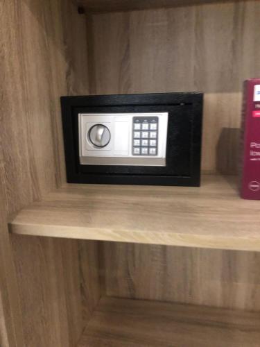 a microwave sitting on a shelf in a room at Apartments Next to Mivida in New cairo
